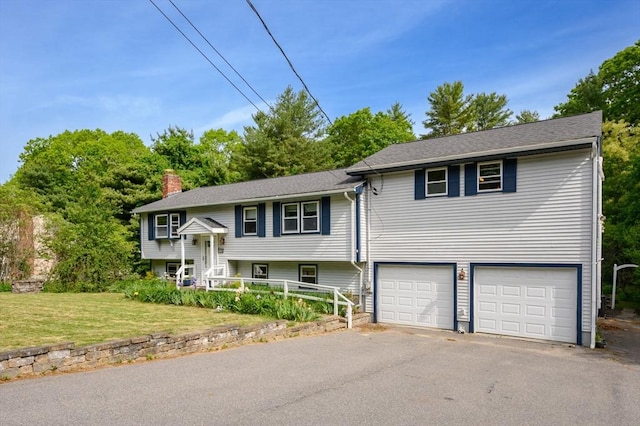 146 Field St, Taunton, MA 02780 - bi-level home with an attached garage, asphalt driveway, a chimney, and a front lawn