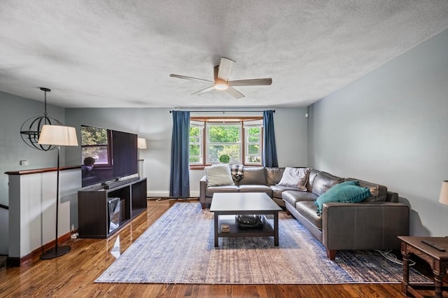 146 Field St, Taunton, MA 02780 - living area with a textured ceiling, a ceiling fan, and wood finished floors
