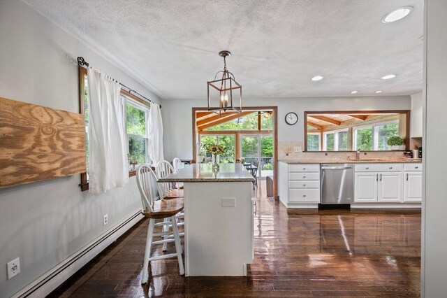 146 Field St, Taunton, MA 02780 - dining area featuring a baseboard heating unit, dark wood-style floors, a chandelier, recessed lighting, and a textured ceiling