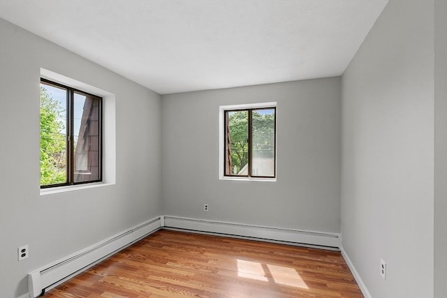 5 Washington St Unit D2, Reading, MA 01867 - unfurnished room with a baseboard radiator, light wood-type flooring, and baseboards