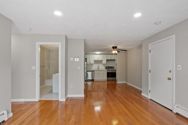5 Washington St Unit D2, Reading, MA 01867 - unfurnished living room with a baseboard heating unit, light wood-style floors, ceiling fan, and recessed lighting