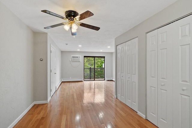 5 Washington St Unit D2, Reading, MA 01867 - corridor with light wood-style floors, a baseboard heating unit, baseboards, a wall mounted air conditioner, and recessed lighting