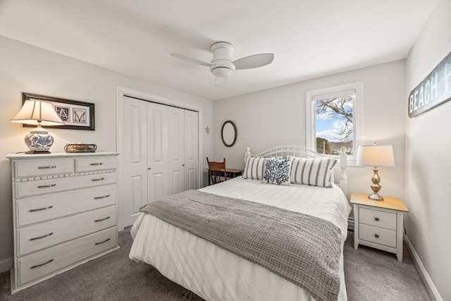 carpeted bedroom featuring ceiling fan, a closet, and baseboards