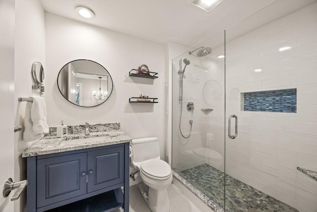 full bath featuring toilet, a shower stall, and vanity