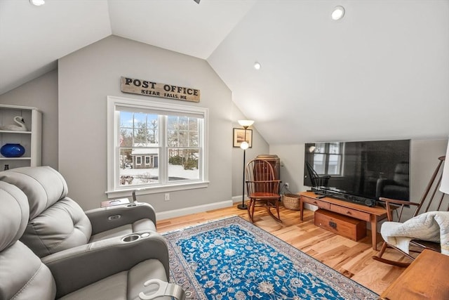 living area with baseboards, vaulted ceiling, and light wood finished floors