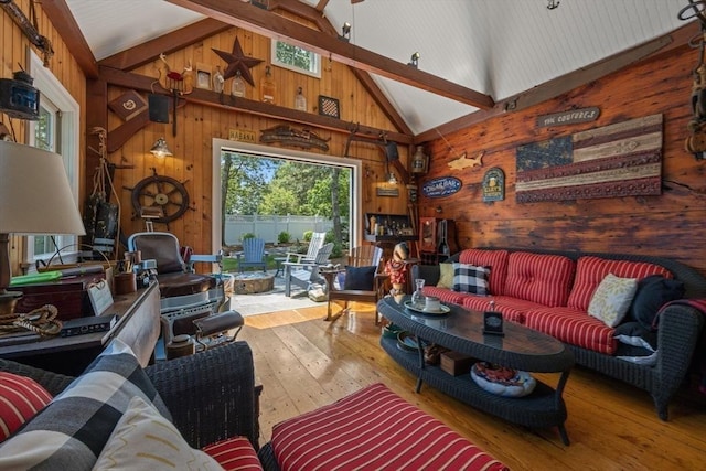 living area with high vaulted ceiling, wood-type flooring, wood walls, and beamed ceiling