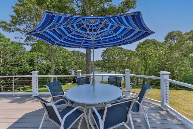 wooden deck with a yard and outdoor dining space