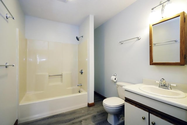 bathroom featuring toilet, shower / bath combination, wood finished floors, vanity, and baseboards