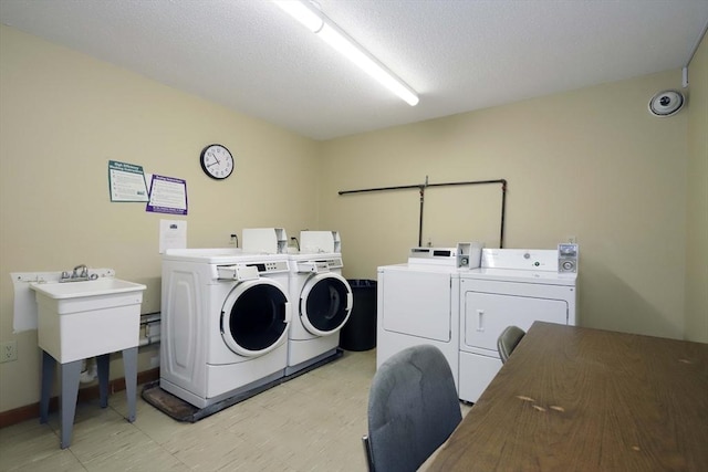 common laundry area with light floors and separate washer and dryer