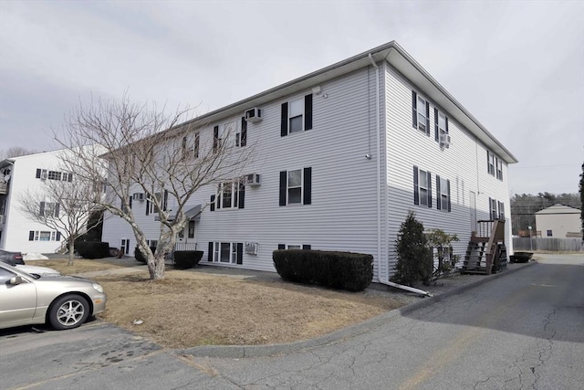 view of property exterior featuring uncovered parking