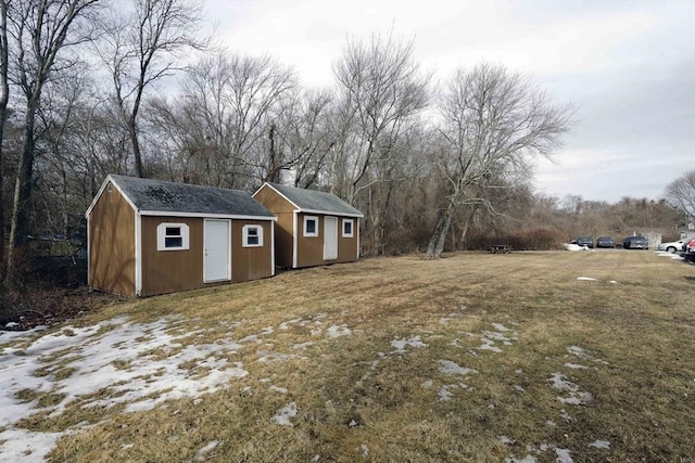 view of yard featuring a storage unit and an outbuilding