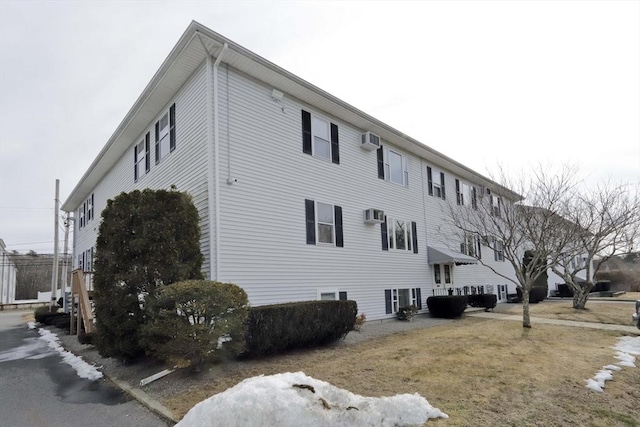 view of home's exterior featuring an AC wall unit