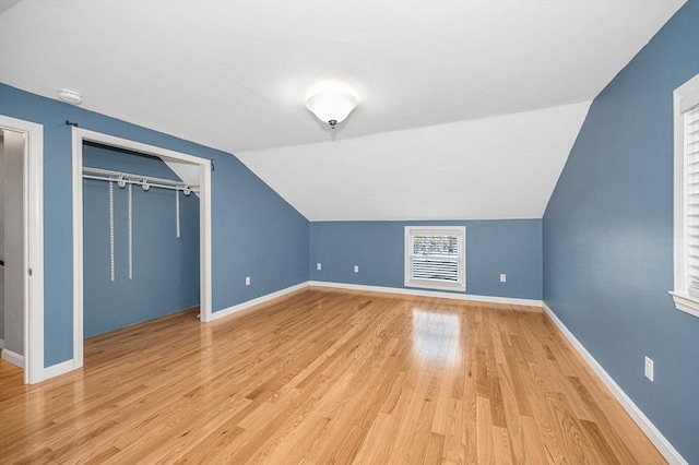 bonus room featuring lofted ceiling and light hardwood / wood-style floors