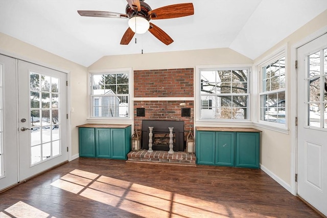 unfurnished sunroom with ceiling fan and lofted ceiling