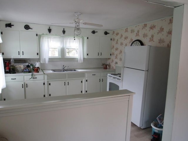 4 Aldrich Ave, Huntington, MA 01050 - kitchen with white appliances, a sink, wallpapered walls, ceiling fan, and white cabinets