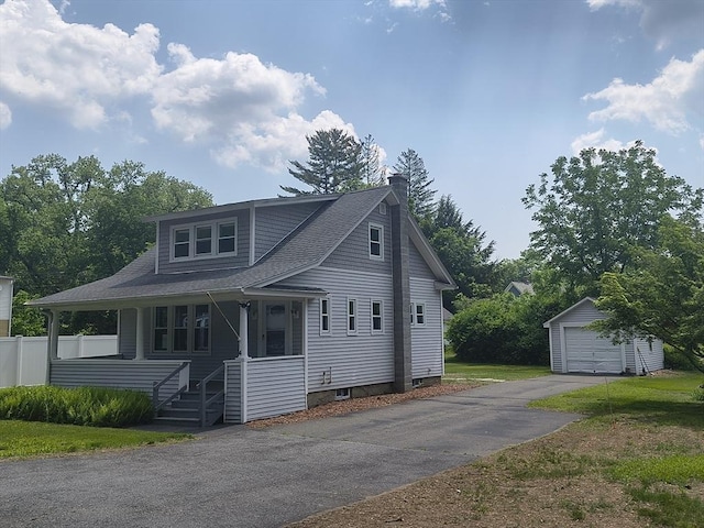 4 Aldrich Ave, Huntington, MA 01050 - view of front of house with an outdoor structure, a chimney, a detached garage, covered porch, and asphalt driveway