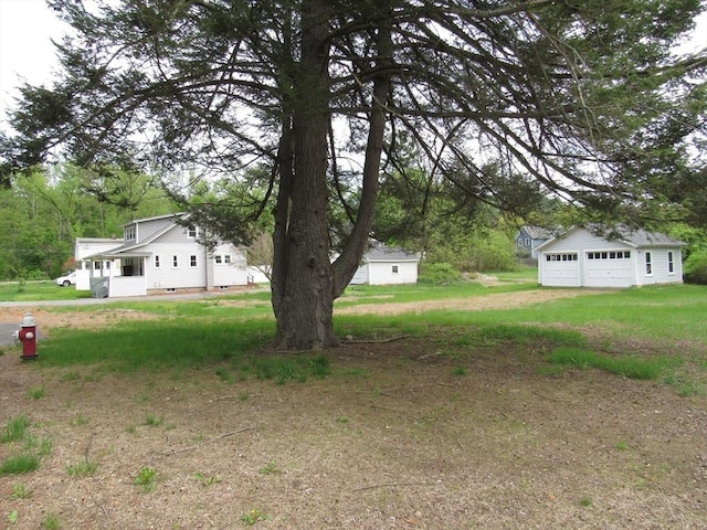 4 Aldrich Ave, Huntington, MA 01050 - view of green lawn with an outbuilding, a garage, and driveway