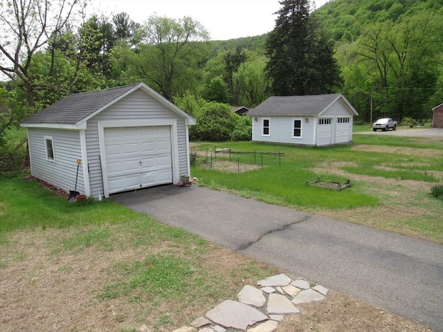4 Aldrich Ave, Huntington, MA 01050 - detached garage featuring a view of trees and driveway
