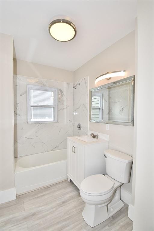 130 Center St, Ludlow, MA 01056 - bathroom featuring a combined bath / shower with marble appearance, vanity, toilet, and wood finished floors