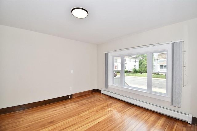130 Center St, Ludlow, MA 01056 - unfurnished room with baseboard heating, light wood-style flooring, and baseboards