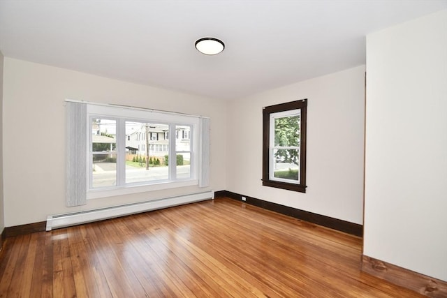 130 Center St, Ludlow, MA 01056 - unfurnished room with a baseboard heating unit, baseboards, and hardwood / wood-style floors