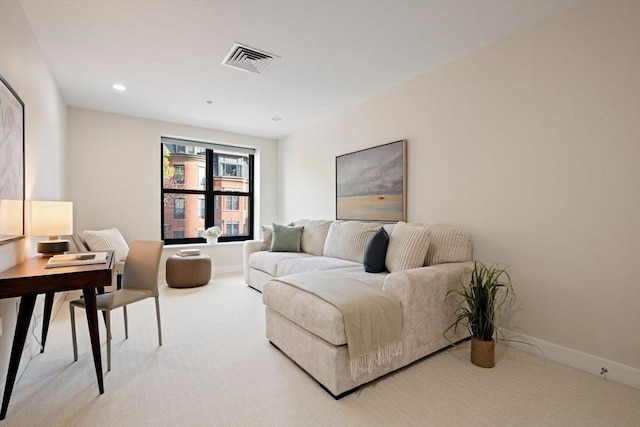 living area with baseboards, light carpet, recessed lighting, and visible vents