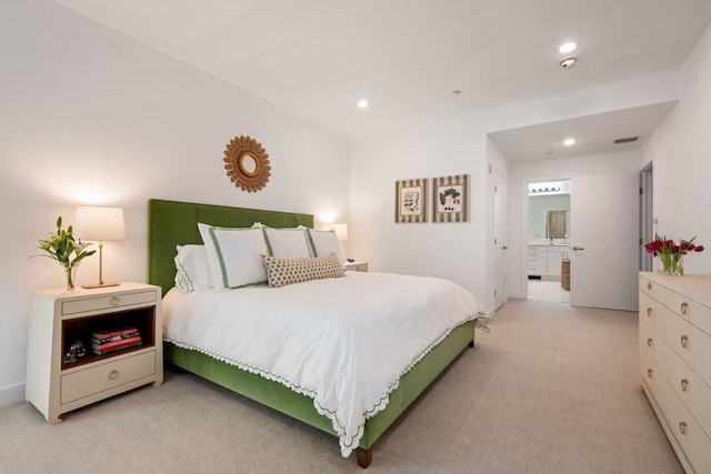 carpeted bedroom with ensuite bathroom