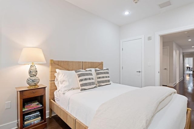 bedroom featuring baseboards, recessed lighting, and dark wood-style flooring