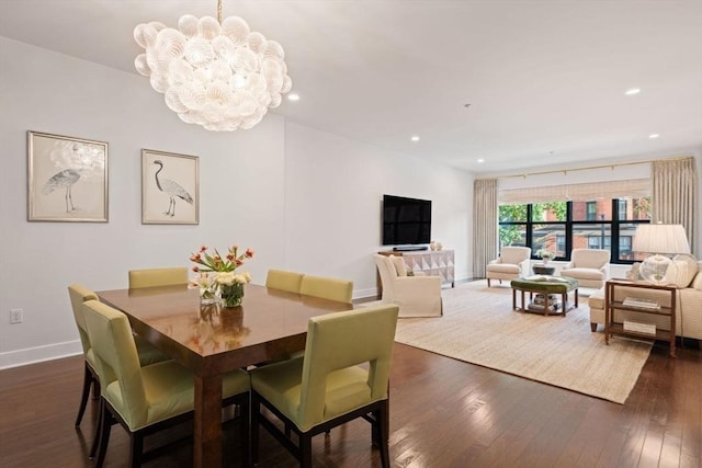 dining space featuring recessed lighting, baseboards, an inviting chandelier, and dark wood finished floors
