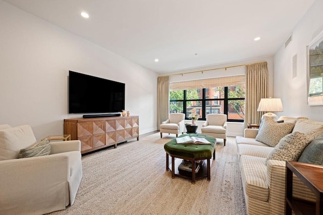 living area featuring visible vents, recessed lighting, baseboards, and light colored carpet