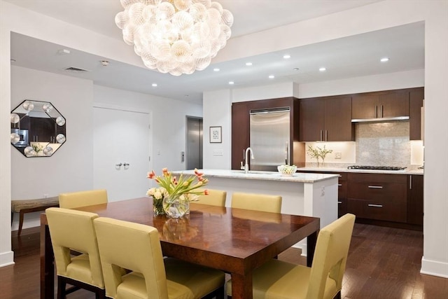 dining area with recessed lighting, visible vents, dark wood finished floors, and a chandelier