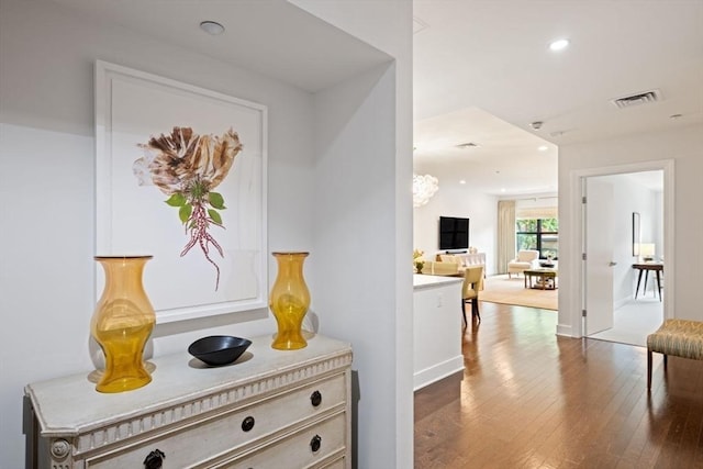 corridor featuring visible vents, recessed lighting, and dark wood finished floors