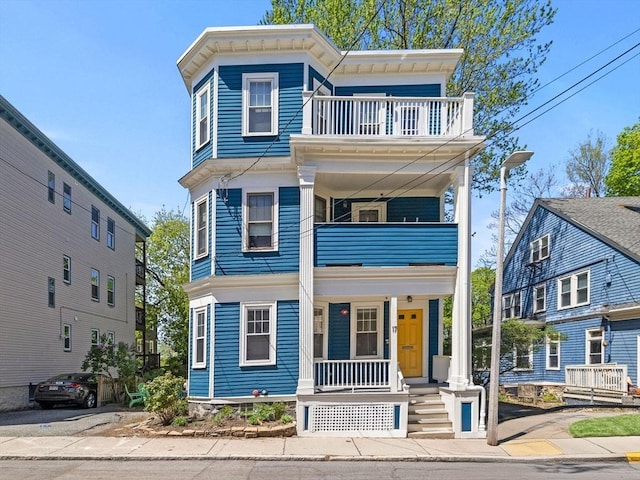 view of front of home featuring a porch and a balcony