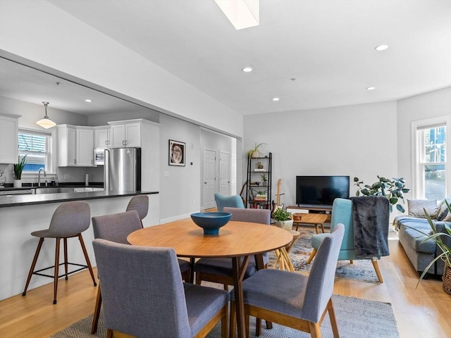 dining space featuring recessed lighting, plenty of natural light, and light wood-style floors