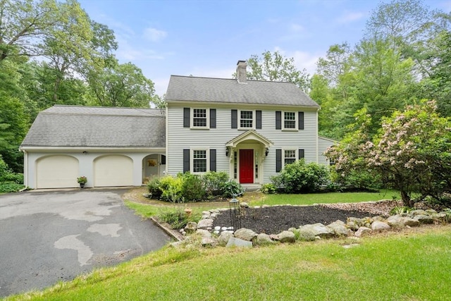 19 Birch St, Millis, MA 02054 - colonial inspired home with a chimney, an attached garage, driveway, a front lawn, and a shingled roof