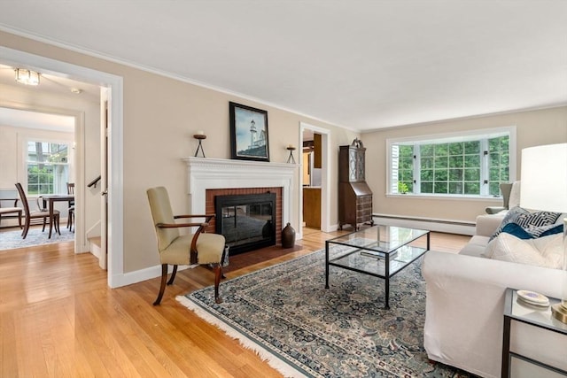 19 Birch St, Millis, MA 02054 - living area with a baseboard radiator, ornamental molding, light wood-type flooring, and a fireplace