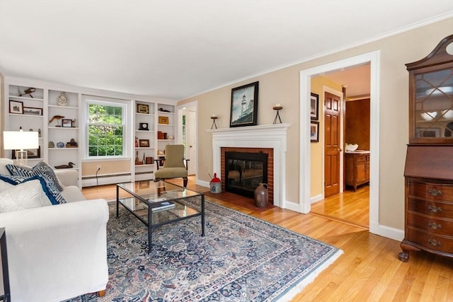 19 Birch St, Millis, MA 02054 - living area featuring wood finished floors, built in shelves, crown molding, a brick fireplace, and a baseboard heating unit