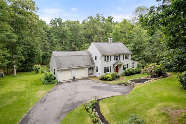 19 Birch St, Millis, MA 02054 - view of front facade with roof with shingles, a chimney, a garage, asphalt driveway, and a front lawn