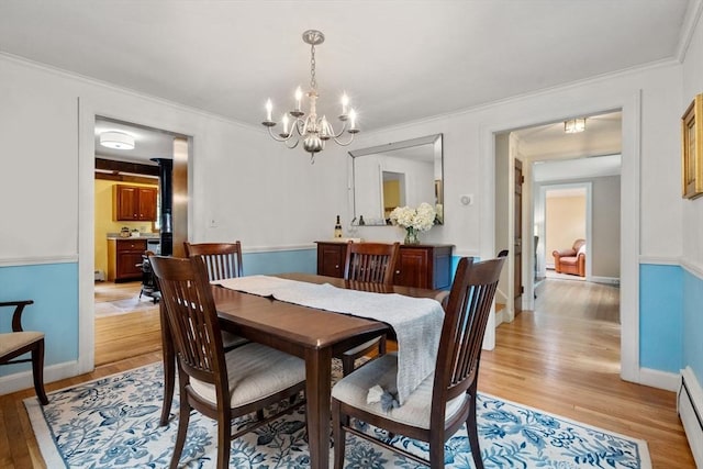 19 Birch St, Millis, MA 02054 - dining room with light wood finished floors, a chandelier, baseboard heating, and ornamental molding