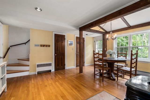 19 Birch St, Millis, MA 02054 - dining room with radiator heating unit, stairway, light wood finished floors, healthy amount of natural light, and beamed ceiling