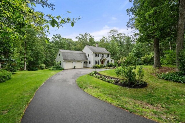19 Birch St, Millis, MA 02054 - colonial inspired home featuring driveway, a chimney, a garage, and a front lawn