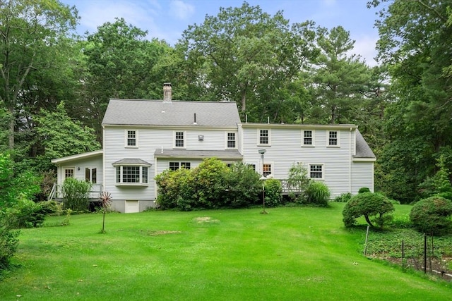 19 Birch St, Millis, MA 02054 - rear view of house with a chimney, a lawn, and view of scattered trees
