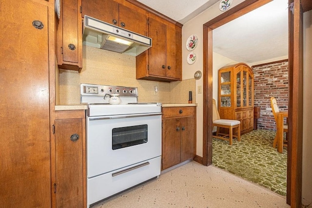 kitchen featuring electric range and brick wall