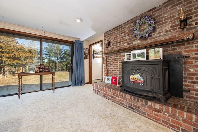 unfurnished living room with carpet floors, a wood stove, and baseboard heating