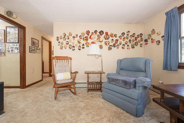 living area with light colored carpet and a baseboard radiator