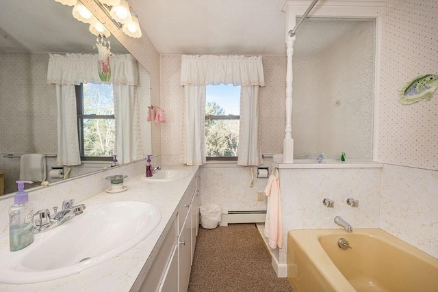 bathroom featuring vanity, a tub to relax in, and baseboard heating