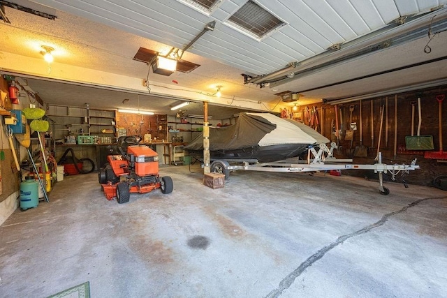 garage featuring a workshop area and a garage door opener