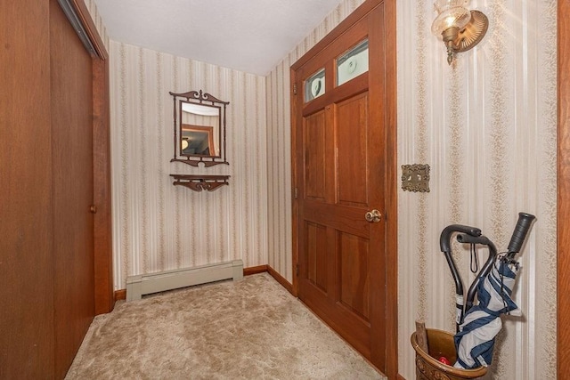 doorway featuring carpet floors and baseboard heating