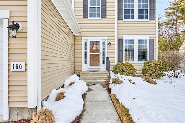 view of snow covered property entrance