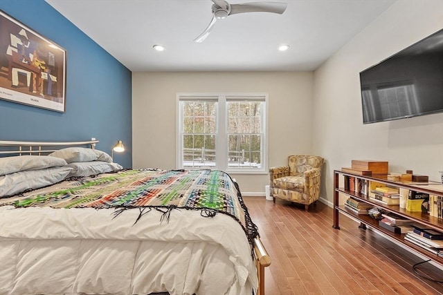 bedroom with light wood finished floors, ceiling fan, baseboards, and recessed lighting